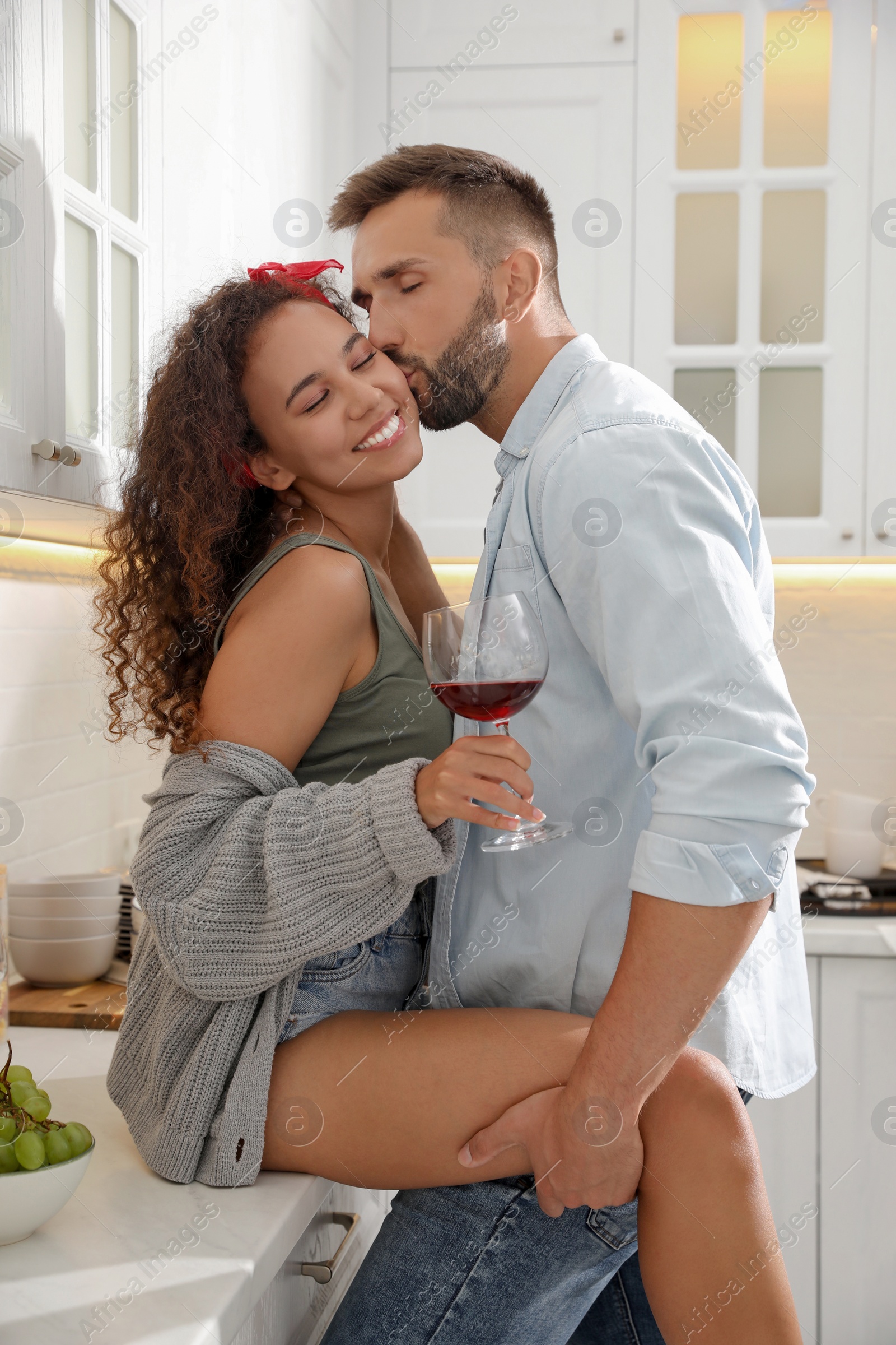 Photo of Lovely couple enjoying time together during romantic dinner in kitchen