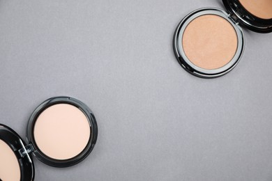 Open face powders on light grey background, flat lay. Space for text