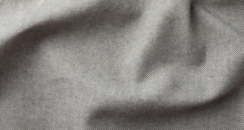 Photo of Texture of grey crumpled fabric as background, top view