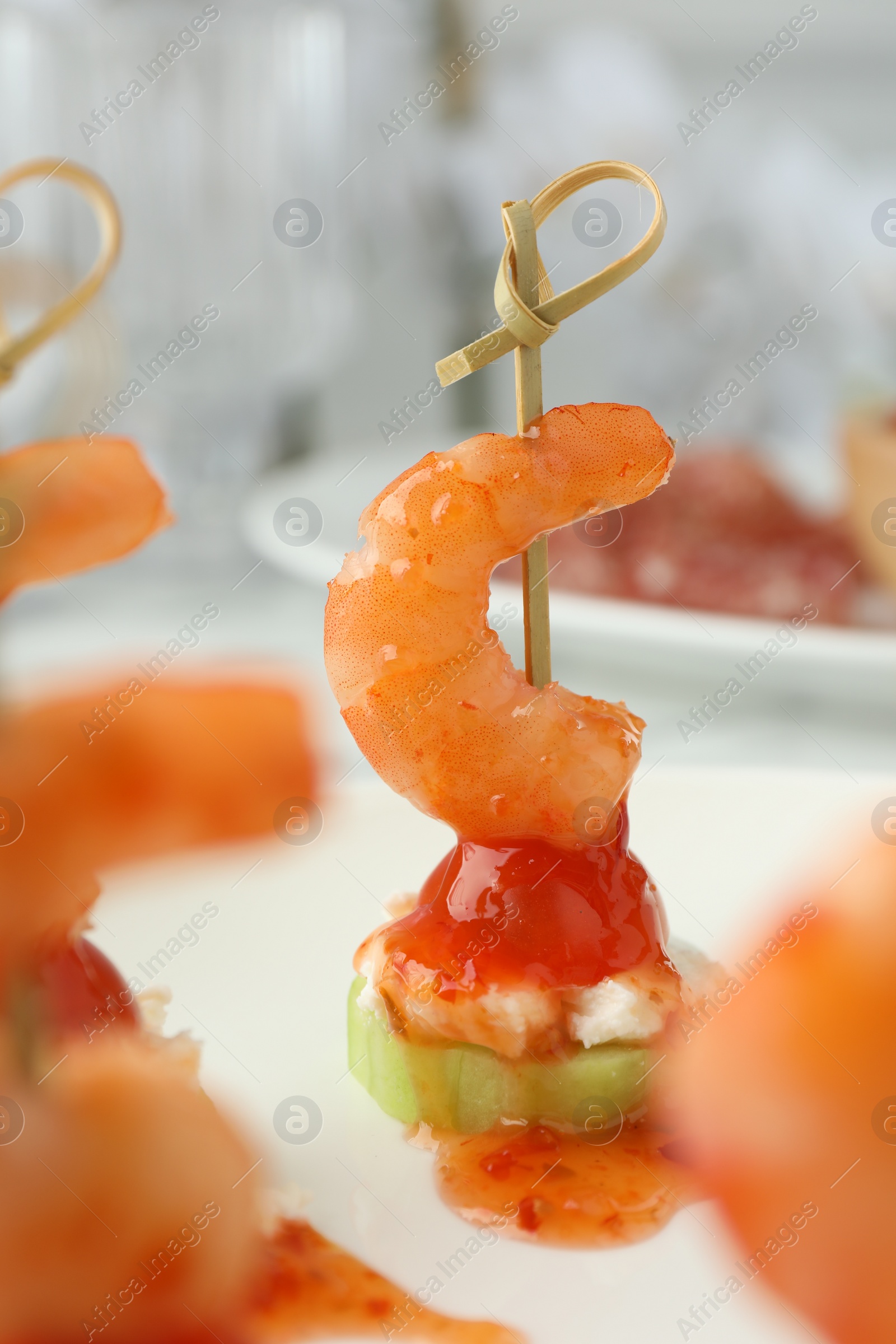 Photo of Tasty canapes with shrimps, vegetables and cream cheese on table, closeup