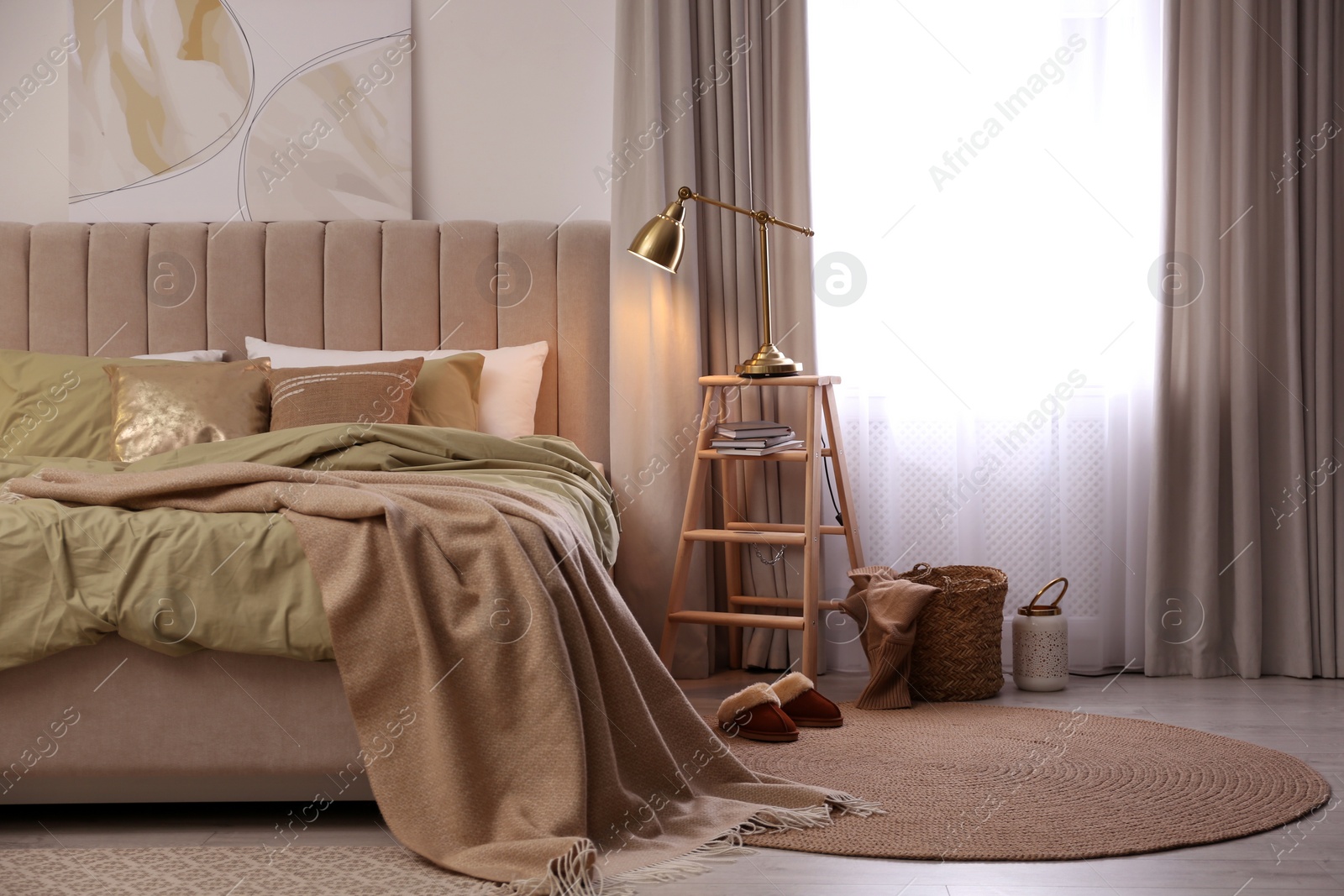 Photo of Comfortable bed with olive green linens in modern room interior