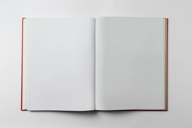 Photo of Open book on white background, top view