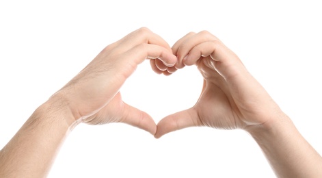 Photo of Young man making heart with his hands isolated on white, closeup