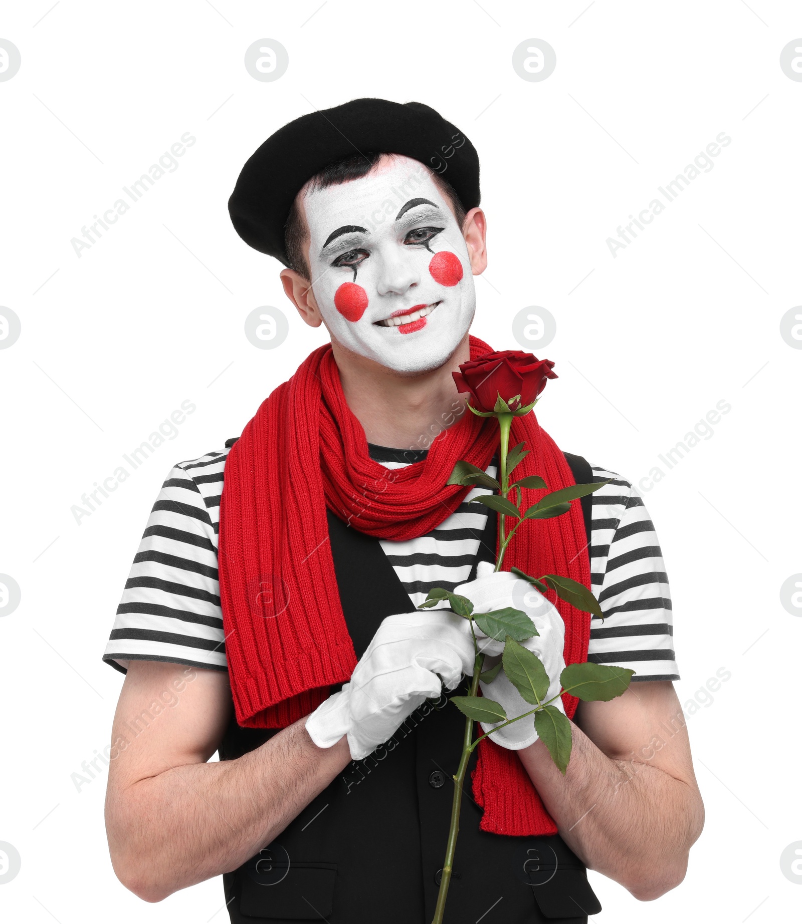 Photo of Funny mime artist with red rose on white background