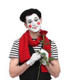 Photo of Funny mime artist with red rose on white background