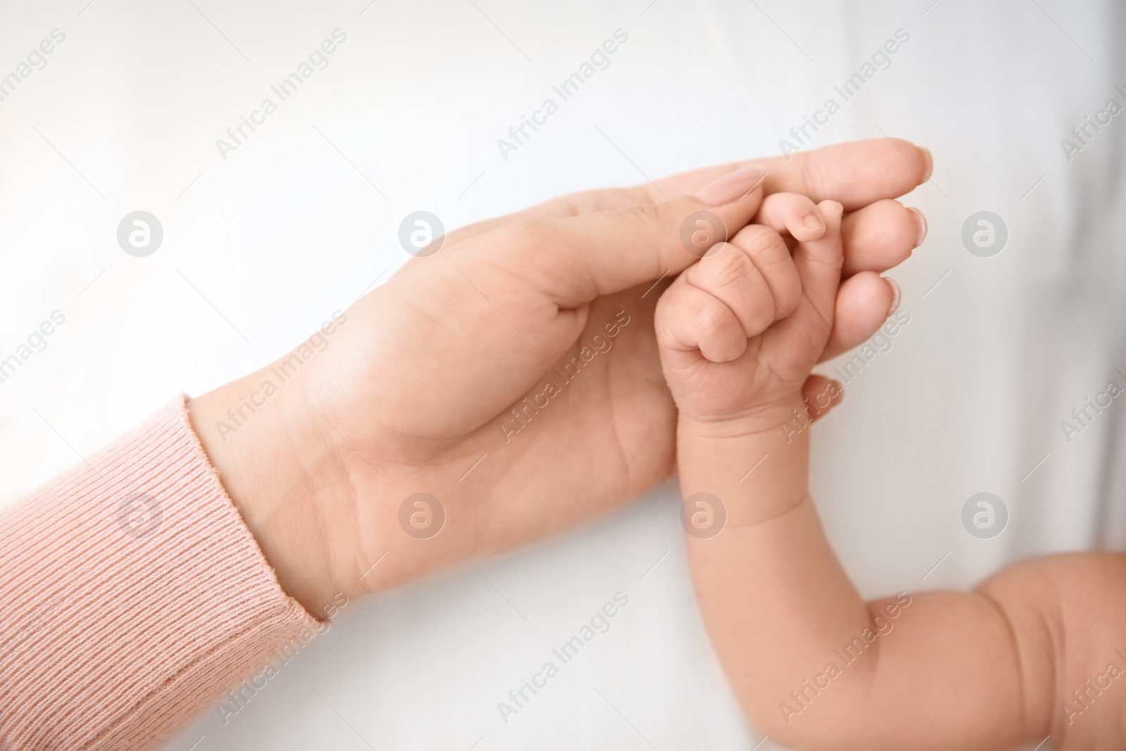 Photo of Mother holding little baby hand