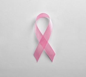 Photo of Pink ribbon on white background, top view. Breast cancer awareness concept