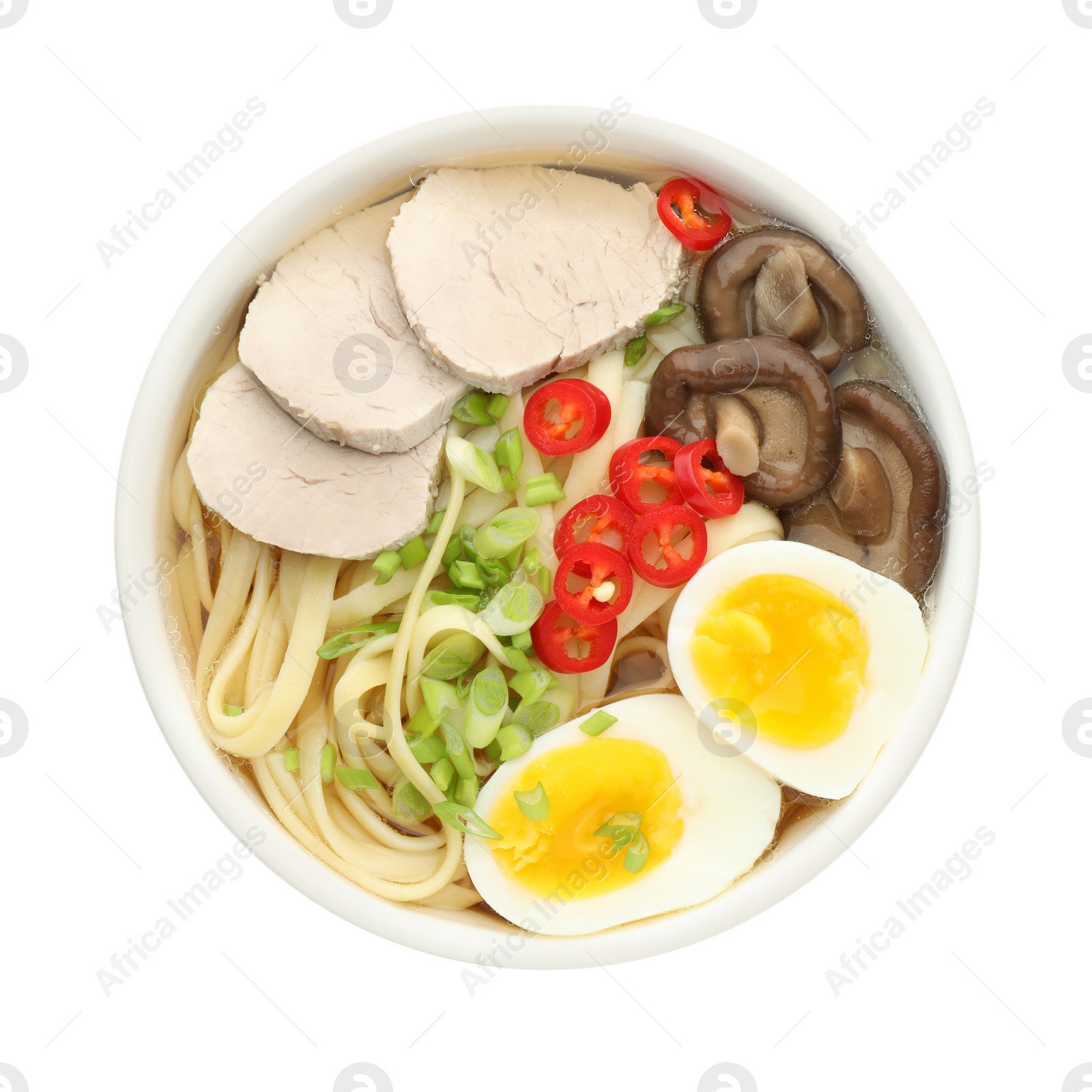 Photo of Delicious ramen with meat and eggs in bowl isolated on white, top view. Noodle soup