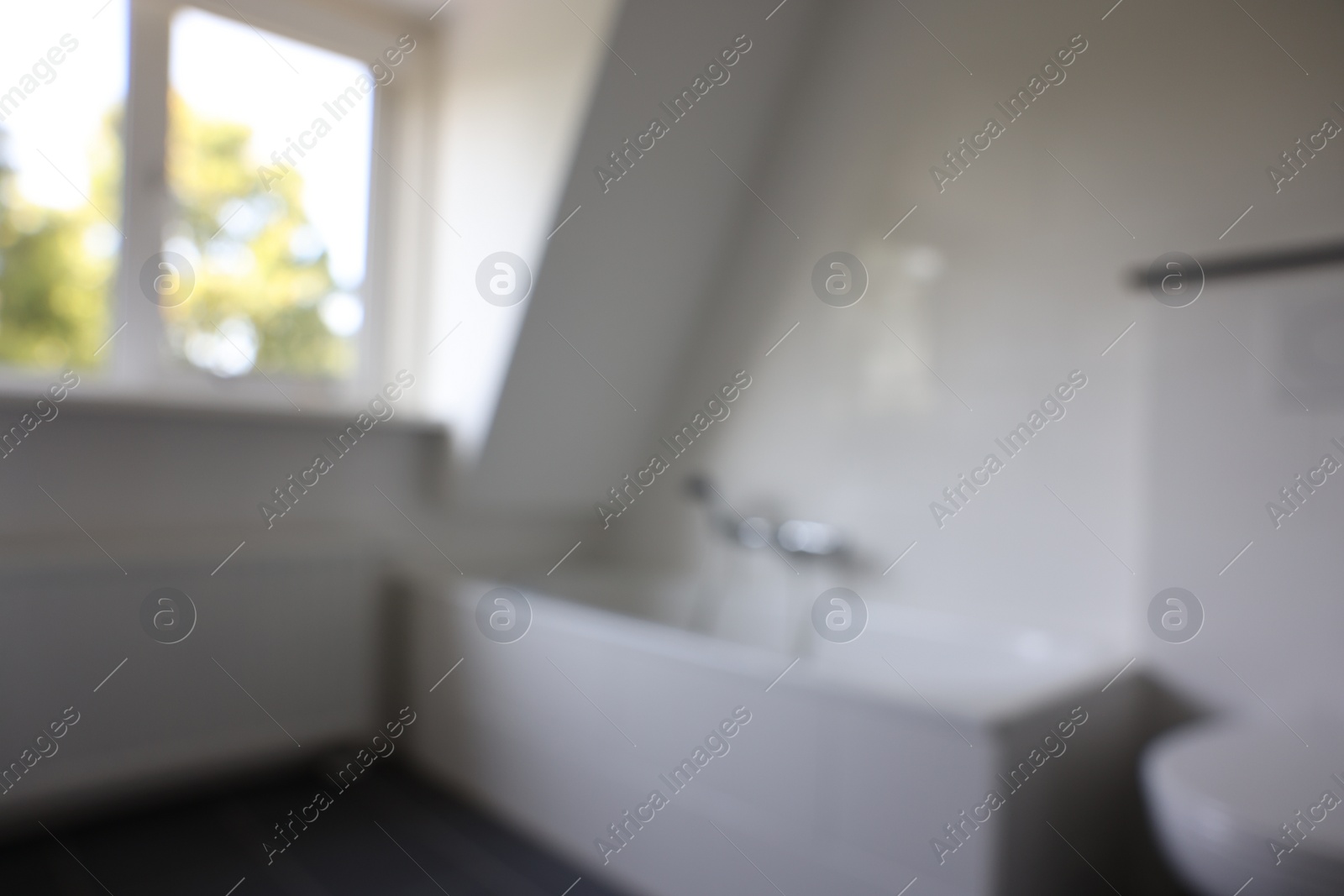 Photo of Blurred view of tub in white bathroom. Interior design