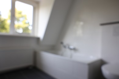 Photo of Blurred view of tub in white bathroom. Interior design