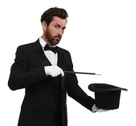 Photo of Magician showing magic trick with top hat on white background