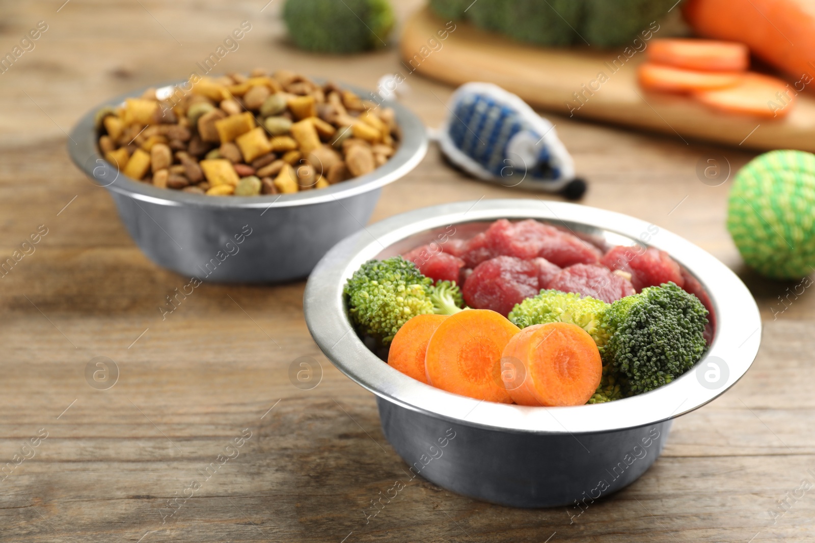 Photo of Pet food and natural ingredients on wooden table, closeup