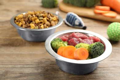 Pet food and natural ingredients on wooden table, closeup
