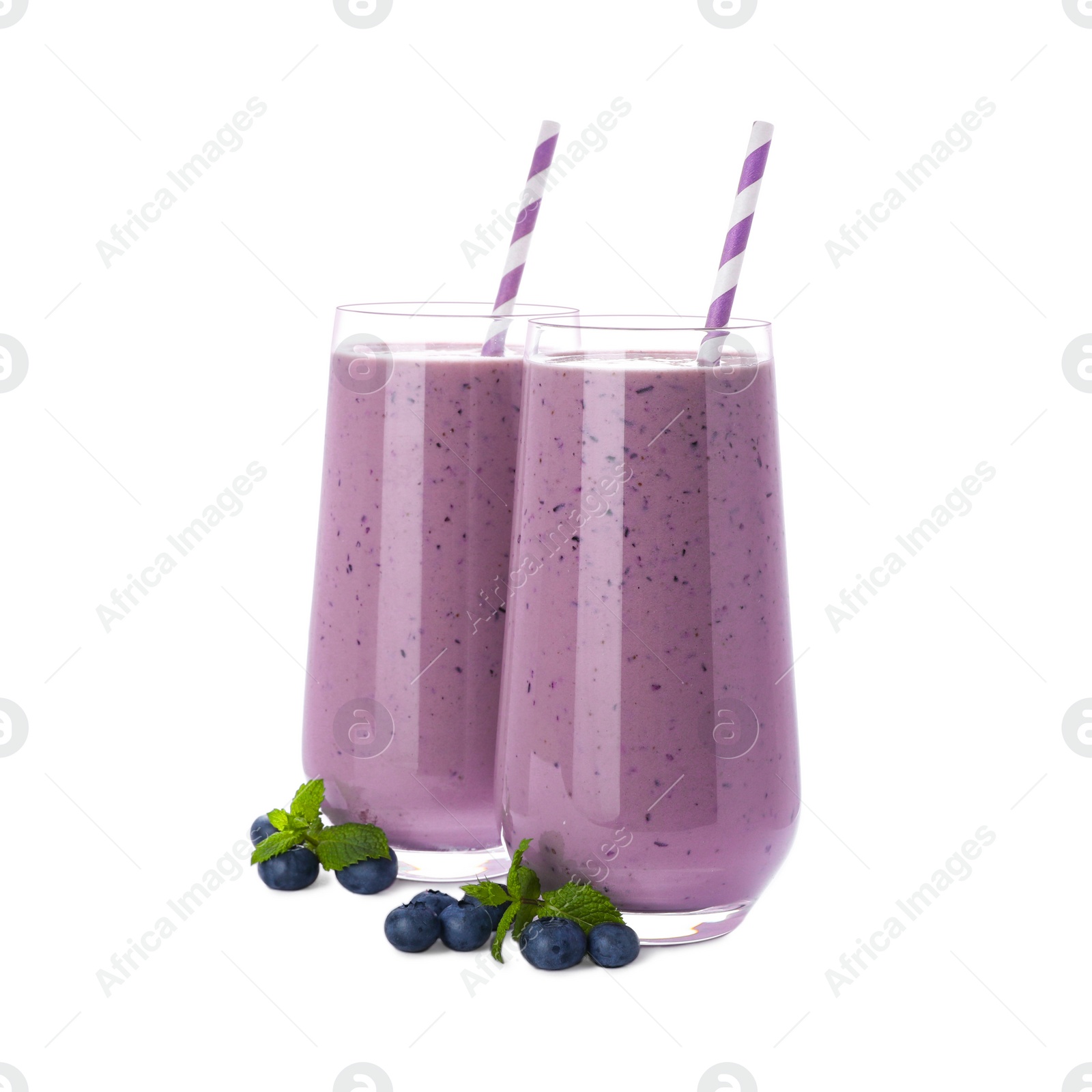 Photo of Glasses of blueberry smoothie with fresh berries and mint on white background
