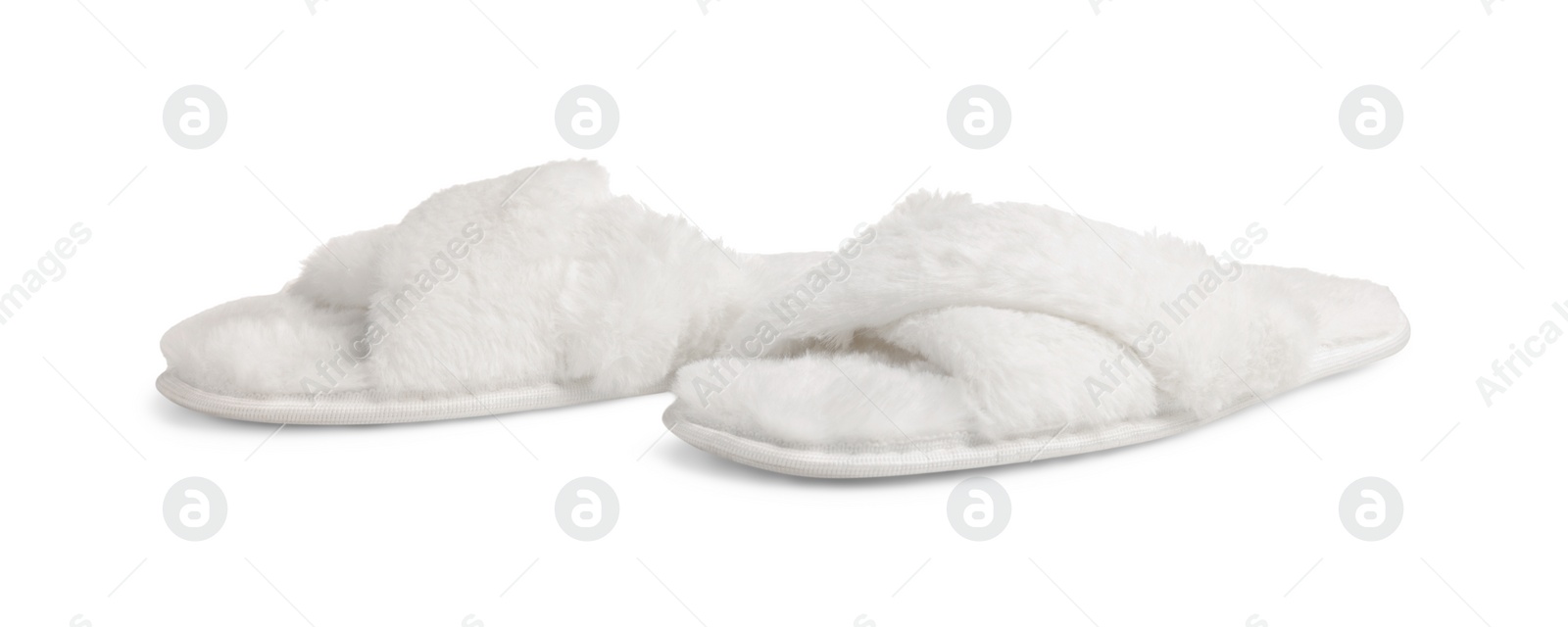 Photo of Pair of soft fluffy slippers on white background