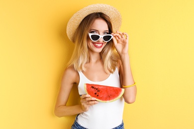 Photo of Pretty young woman with juicy watermelon on color background