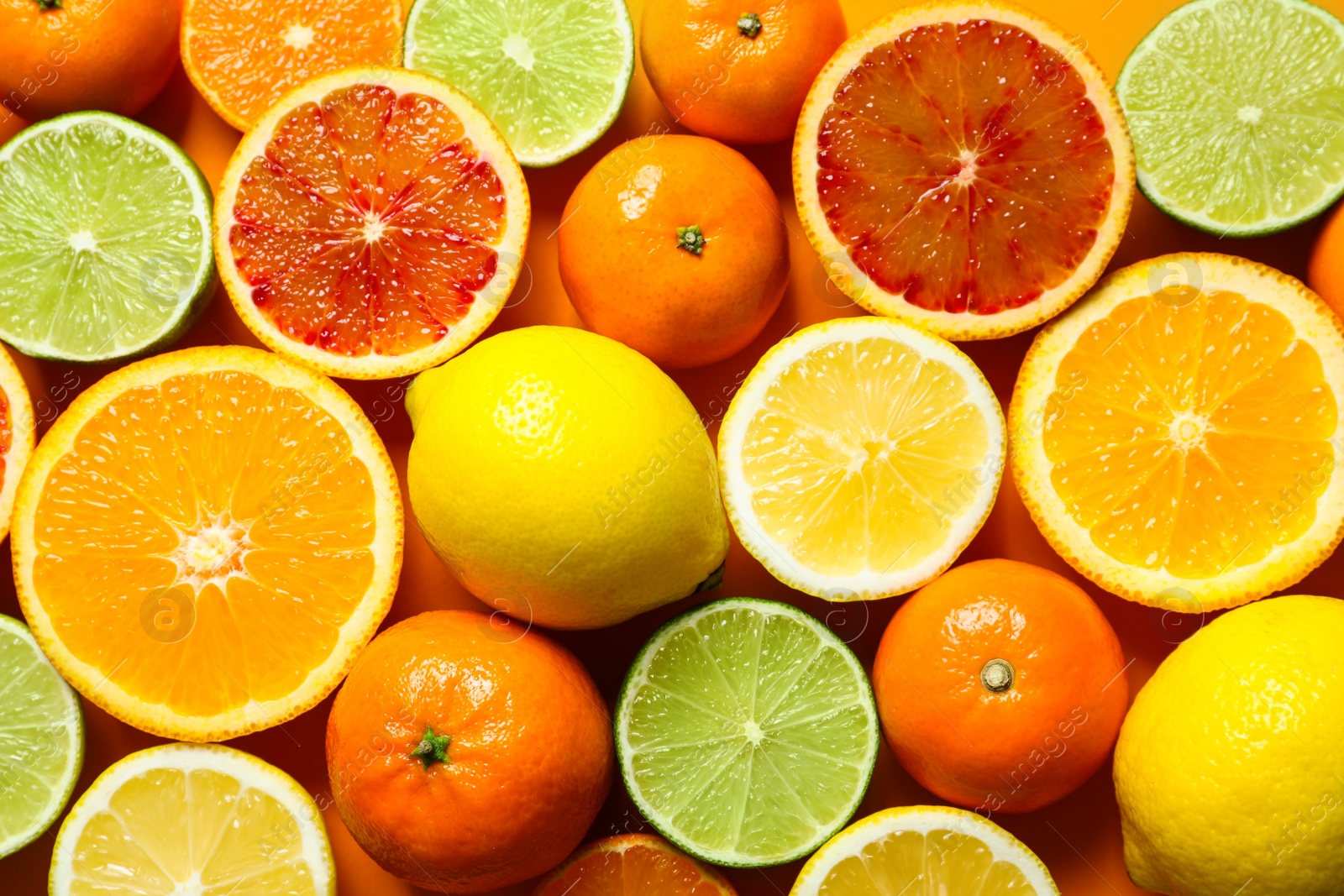 Photo of Different citrus fruits on color background, top view