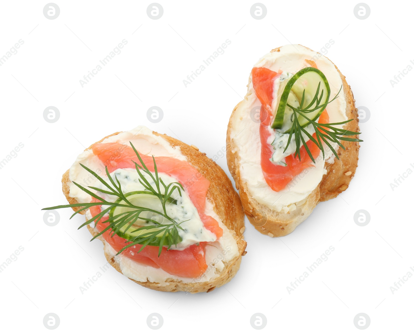 Photo of Tasty canapes with salmon, cucumber, cream cheese and dill isolated on white, top view