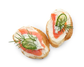Photo of Tasty canapes with salmon, cucumber, cream cheese and dill isolated on white, top view