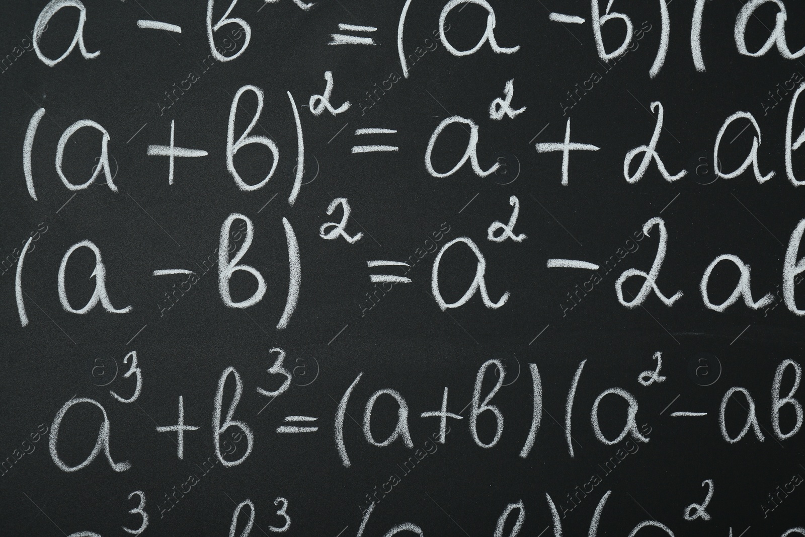 Photo of Many different math formulas written on chalkboard, closeup