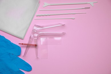 Photo of Sterile gynecological examination kit on pink background, flat lay. Space for text