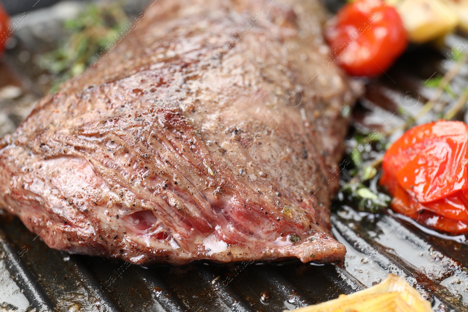 Photo of Delicious grilled beef meat and vegetables in pan, closeup