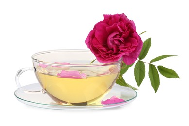 Aromatic herbal tea in glass cup, peony and green leaves isolated on white