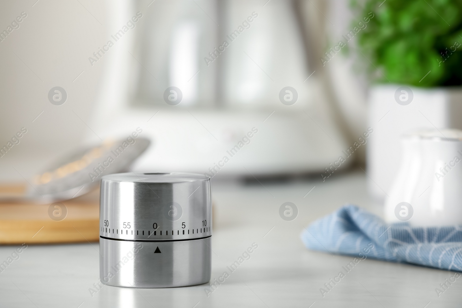Photo of Kitchen timer on white table indoors. Space for text