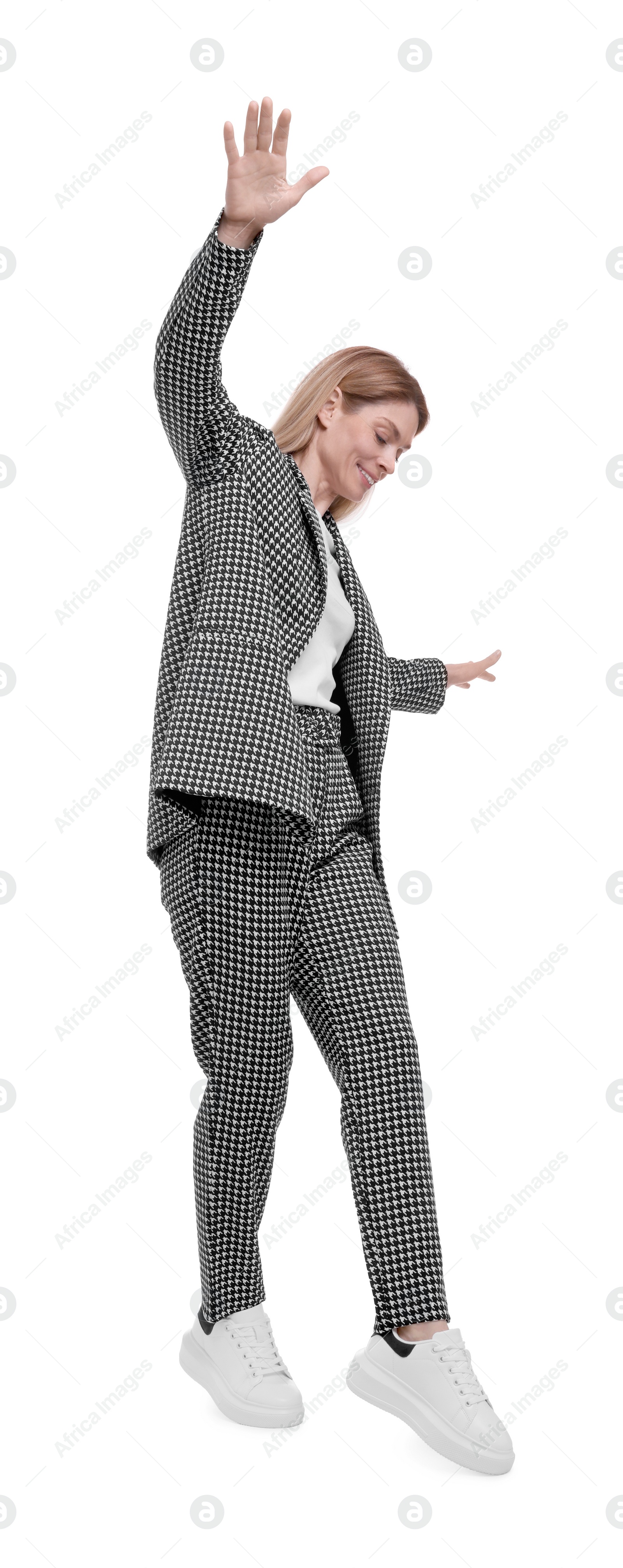 Photo of Beautiful happy businesswoman in suit walking on white background