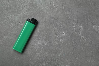 Photo of Stylish small pocket lighter on grey table, top view. Space for text