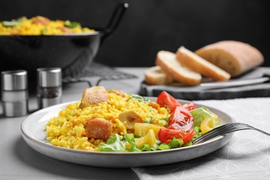 Delicious pilaf with chicken meat on light grey table