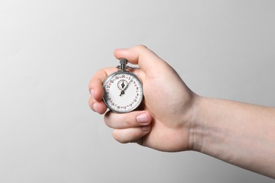 Photo of Man holding vintage timer on white background, closeup