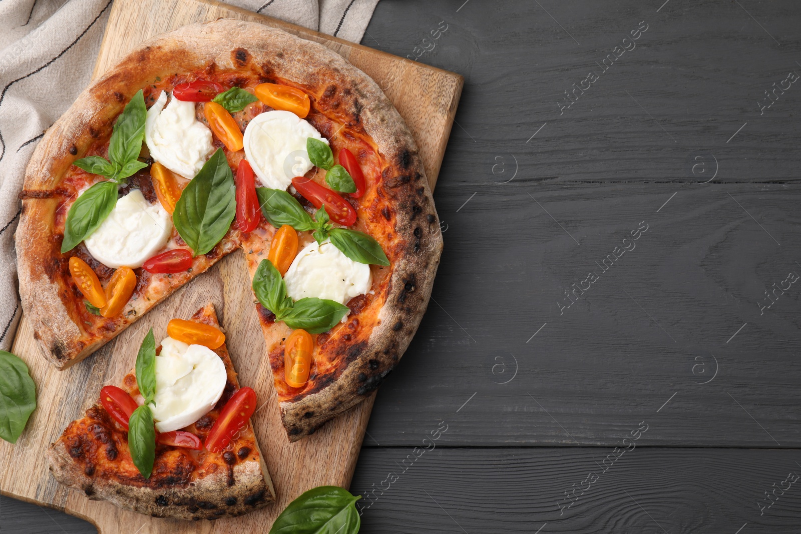 Photo of Delicious pizza with burrata cheese, tomatoes and basil on grey wooden table, top view. Space for text