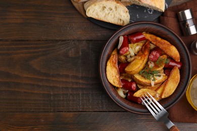 Photo of Delicious baked potato with thin dry smoked sausages in bowl served on wooden table, flat lay. Space for text