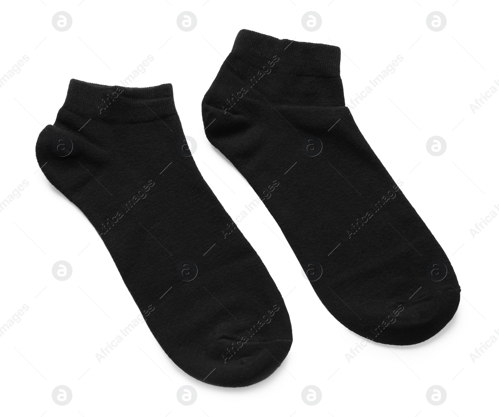 Photo of Pair of black socks on white background, top view