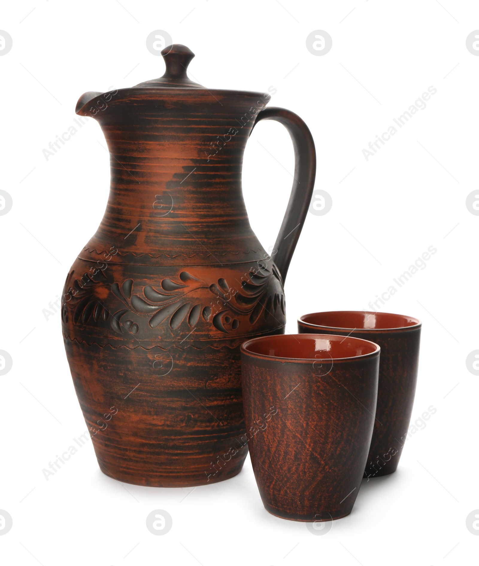 Photo of Brown clay jug and cups on white background