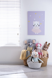 Funny stuffed toys on floor near window. Decor for children's room interior