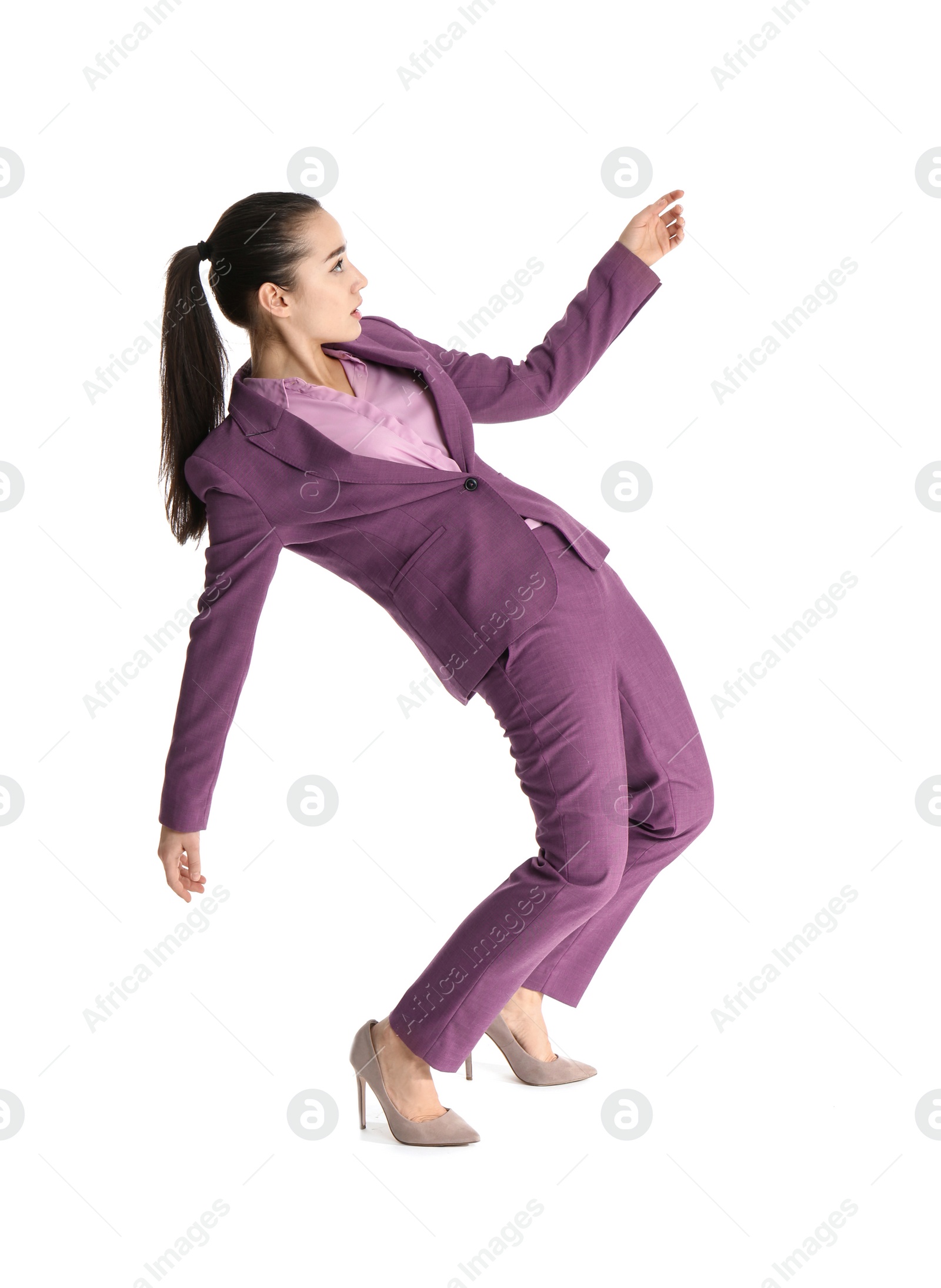 Photo of Businesswoman attracted to magnet on white background