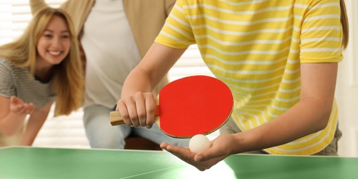 Woman playing ping pong with friends indoors, closeup. Banner design