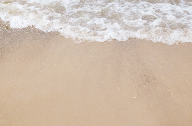 Photo of Beautiful sea coast with wet sand, closeup