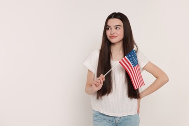 4th of July - Independence Day of USA. Happy girl with American flag on white background, space for text