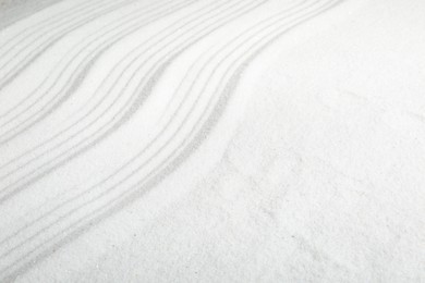 Zen rock garden. Wave pattern on white sand