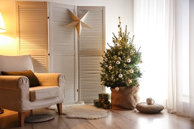 Stylish room interior with elegant Christmas decor