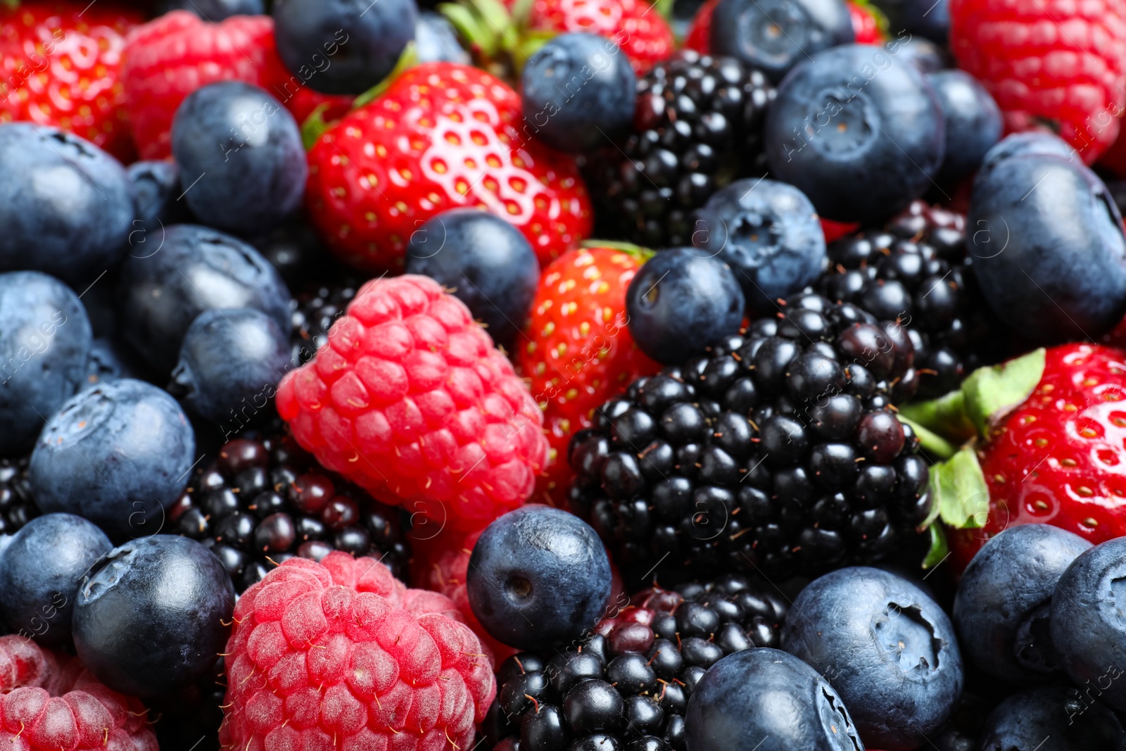 Photo of Mix of different ripe tasty berries as background, closeup view