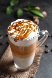 Photo of Glass cup with delicious caramel frappe on table