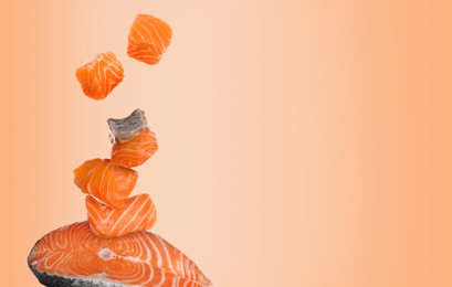 Image of Cut fresh salmon falling on coral gradient background, space for text