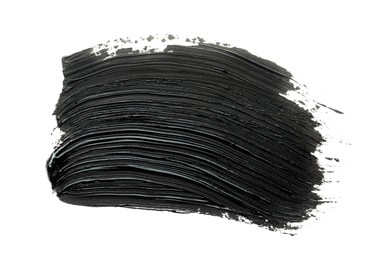 Photo of Brushstrokes of black oil paint on white background, top view