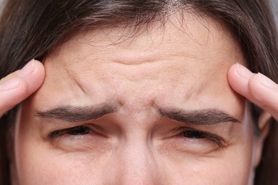 Photo of Closeup view of woman with wrinkles on her forehead