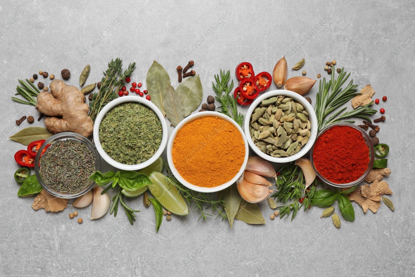 Photo of Flat lay composition with different natural spices and herbs on light grey table