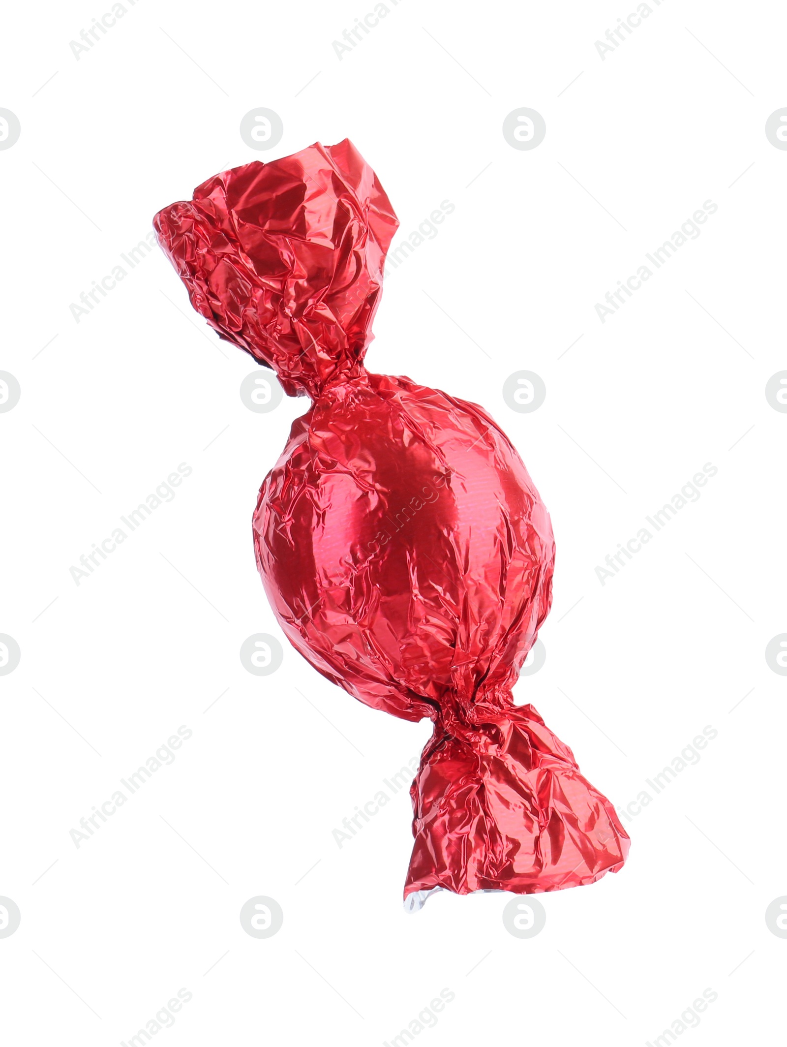 Photo of Tasty candy in red wrapper isolated on white